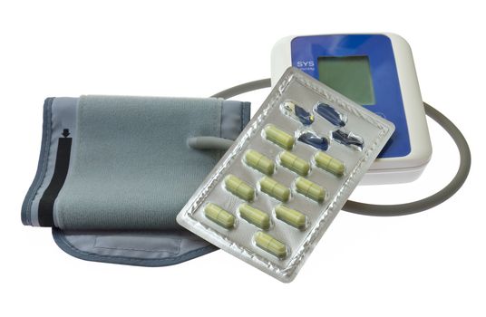 Blood pressure monitor  and blister capsule on white background