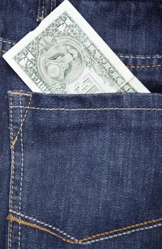 US dollar in the pocket of blue jeans. Close-up photo