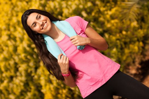 Sport woman with blue towell enjoying after fitness session