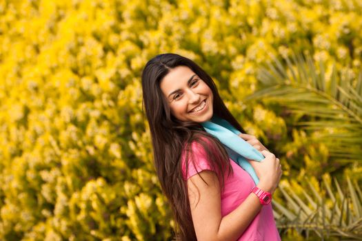 Sport woman with blue towell enjoying after fitness session