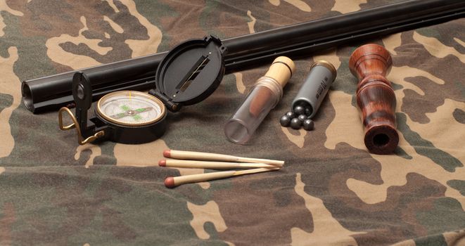 Subjects of the hunting ammunition on a camouflage fabric.