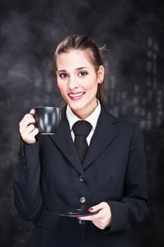 Pretty young woman holding black cup of coffee