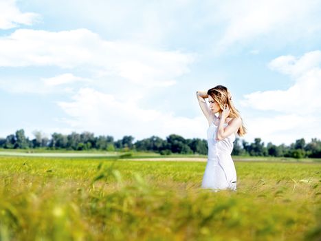 Woman at wheat field on sunny day