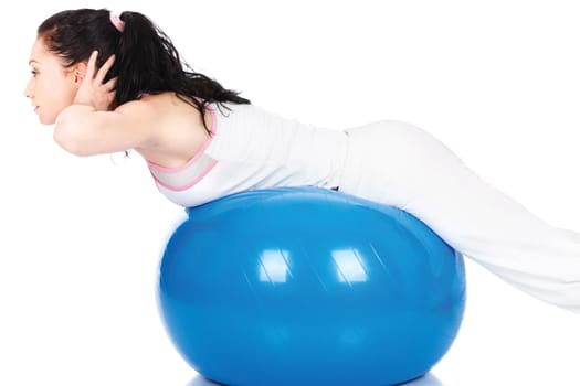 Pretty woman stretching on the blue ball, isolated on white