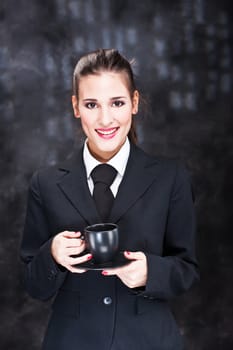 Pretty young woman holding black cup of coffee