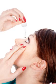 Woman putting drops in eye, isolated on white