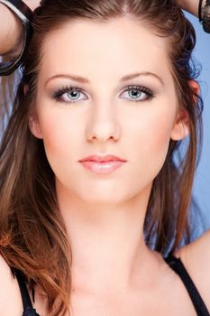 Pretty woman with blue eyes on blue background