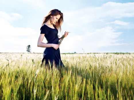 Woman at wheat field on sunny day