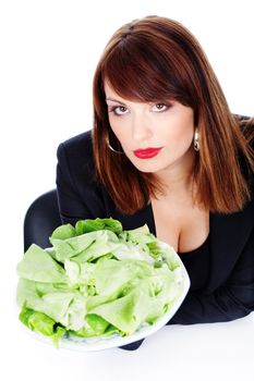 beautiful brunette woman is offering green salad on white plate, on white background