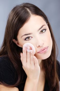 pretty woman applying make up