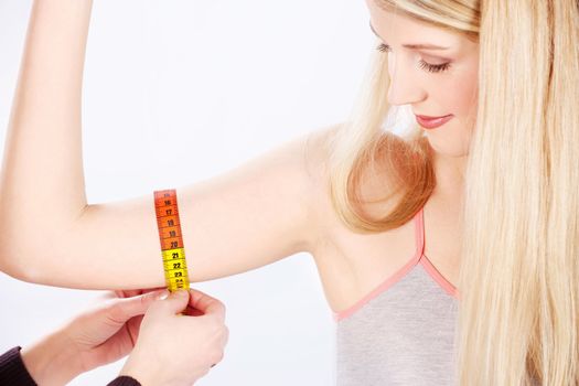 Measure tape around woman's arm