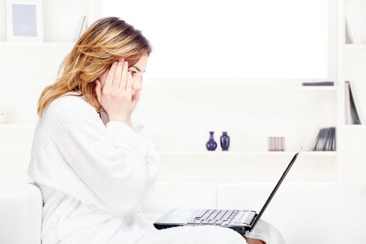 teenage girl at home in bathrobe chatting on computer