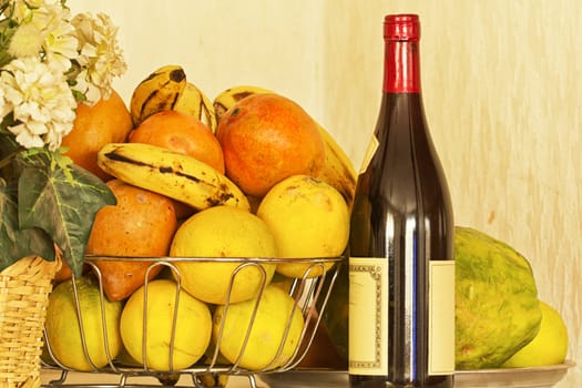 Delicious ripe oranges and mangoes piled up in a silver fruit bowl