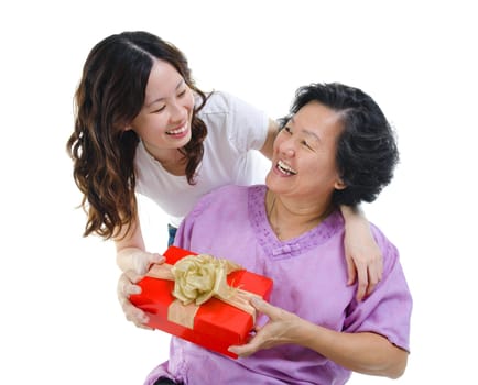 Happy Mixed race Asian mother receiving present from her daughter