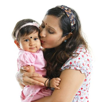 Asian Indian mother kissing her baby girl, isolated on white background