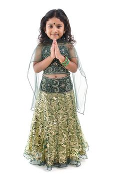 Cute little Indian girl in a greeting pose, isolated white background