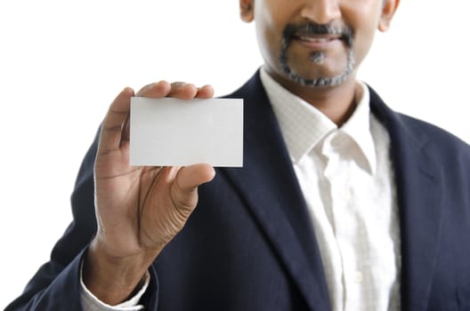 Mature Asian Indian businessman holding business card, focus on hand over white background