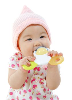 Beautiful mixed race Asian baby girl biting with her toys.
