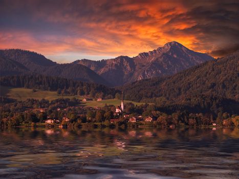 Mountain landscape with majestic sky and reflection in water