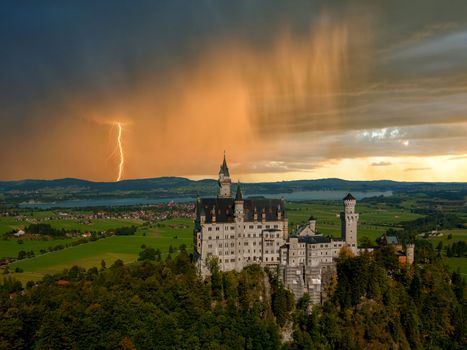 Landscape with Neuschwanstein castle. Thunderstorm with rain and lightning on background