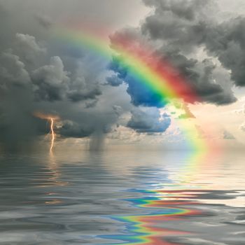 Colorful rainbow over ocean, thunderstorm with rain and lightning on background