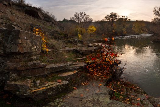 Evening landscape on rocky coast of the river