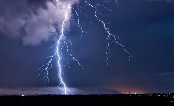 Big lightning in the stormy sky over a city