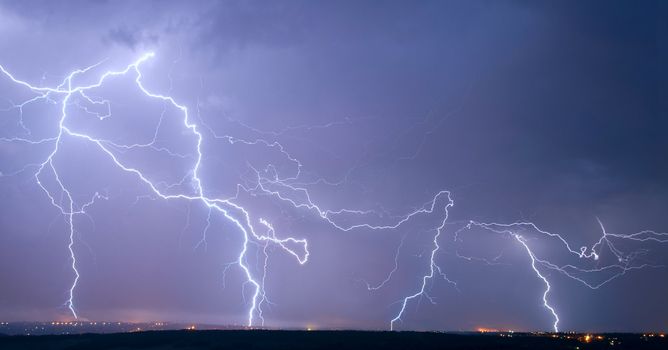 Many big lightning in the stormy sky over a city