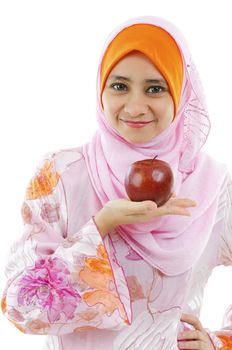 Young Muslim woman holding an apple on palm, healthy eating concept