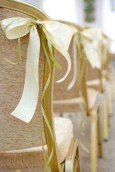 Empty wedding chairs elegantly decorated with bow