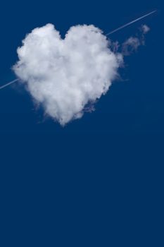 Pierced heart shaped cloud isolated on blue sky