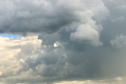 Cloudy sky full of deep grey thunder clouds on the sunset