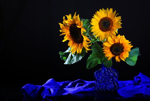 Still life with sunflowers in glass vase 