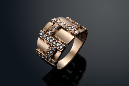 Golden ring with diamonds over black background