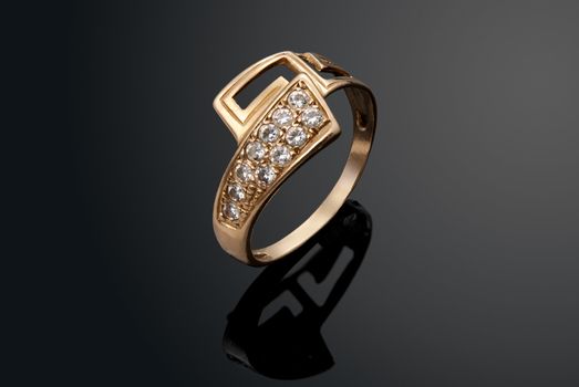 Golden ring with diamonds over black background