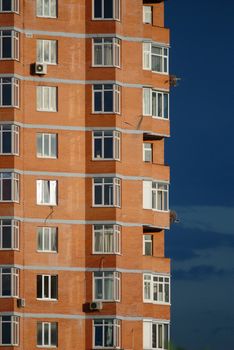Architectural abstract of modern multi apartments building in a sunset (recent development)