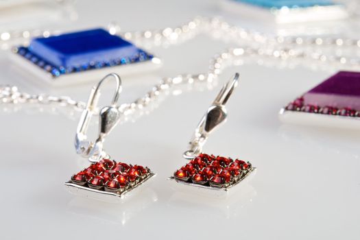 Earrings with diamonds over white background