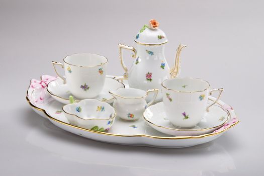 Hand painted tea service on white 