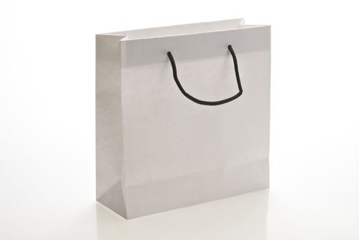 White paper bag with handle isolated on a white background. Clipping path included.