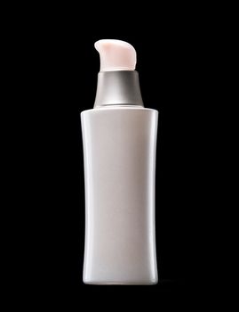White bottle of cosmetics with pink covers on a black background