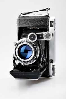 Old vintage photo camera isolated on white background