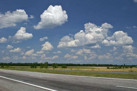 Empty road and cloudy blue sky