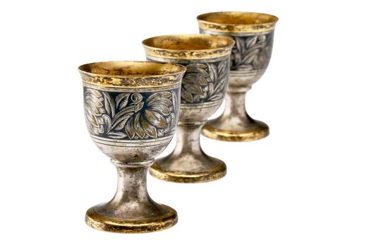 Three ancient wine cup in a line isolated over white background