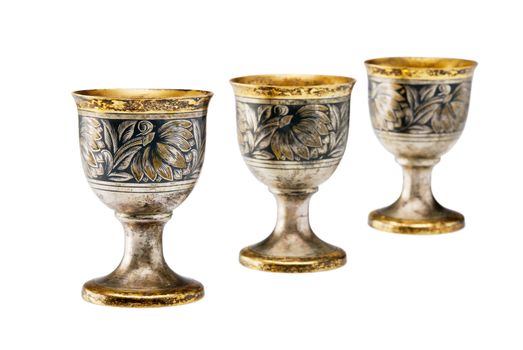 Three ancient wine cup in a line isolated over white background