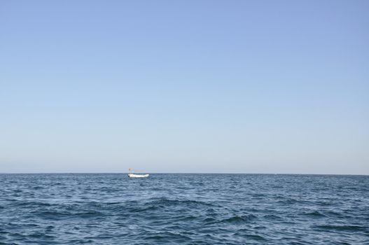 A boat sailing in the clear blue waters of the Indian Ocean on a bright sunny day