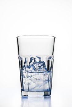 Glass with ice cubes isolated on white background