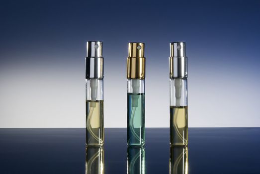bottles with perfume isolated on gradient background