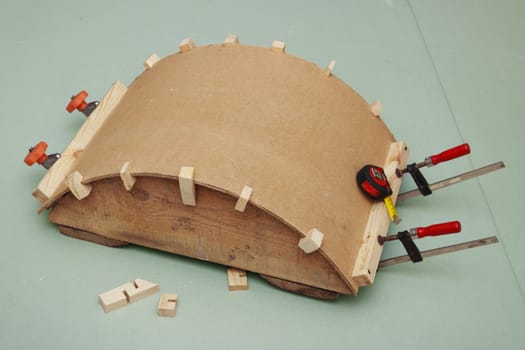Gluing the arch of hardboard  on a convex rule