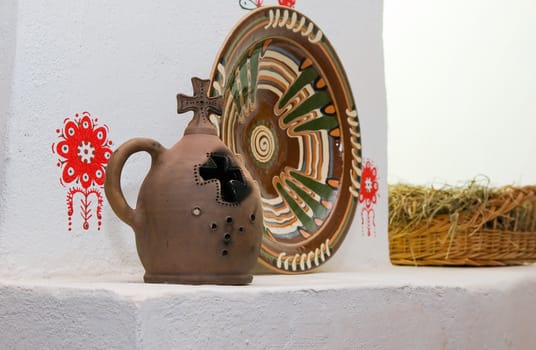 clay vase and bowl  against a background of painted plaster walls