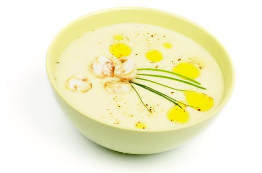 Mushroom Creamy Soup with Champignon and Greens in Yellow Bowl isolated on white background